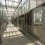 Hallway in a greenhouse with glass walls and ceiling