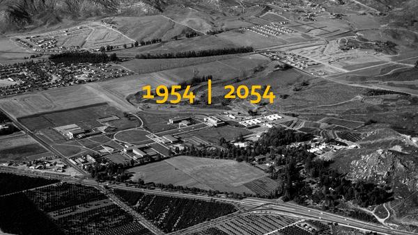 An image of the UCR campus at it's founding in 1954. The numbers "1954 | 2054" are written in gold on the image.